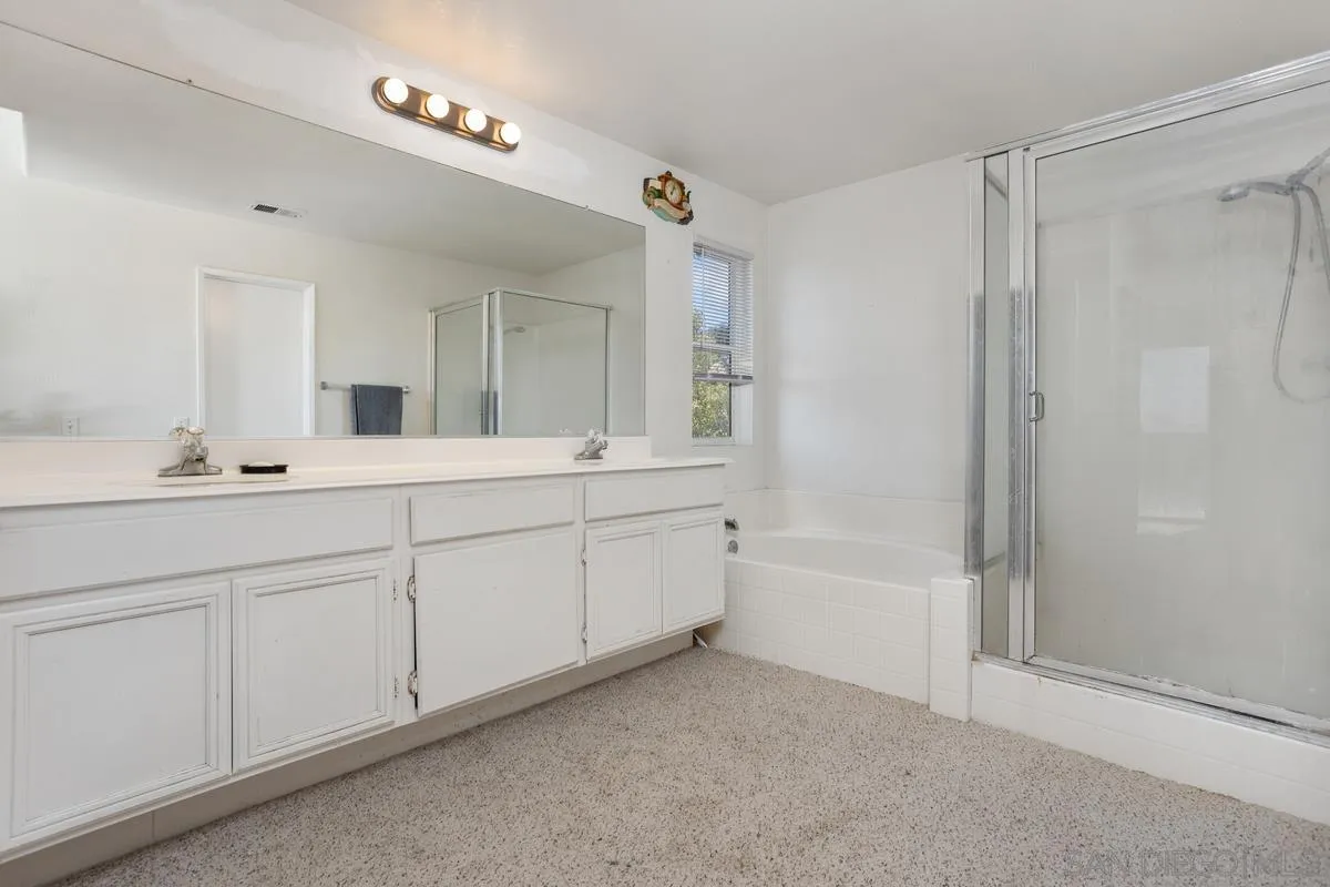 408 Shadow Tree Drive Oceanside, CA 92058 - Photo 21 of 29 a spacious bathroom with a double vanity sink a mirror and a bathtub
