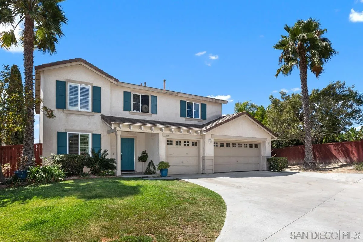 408 Shadow Tree Drive Oceanside, CA 92058 - Photo 29 of 29 a front view of a house with a yard and garage