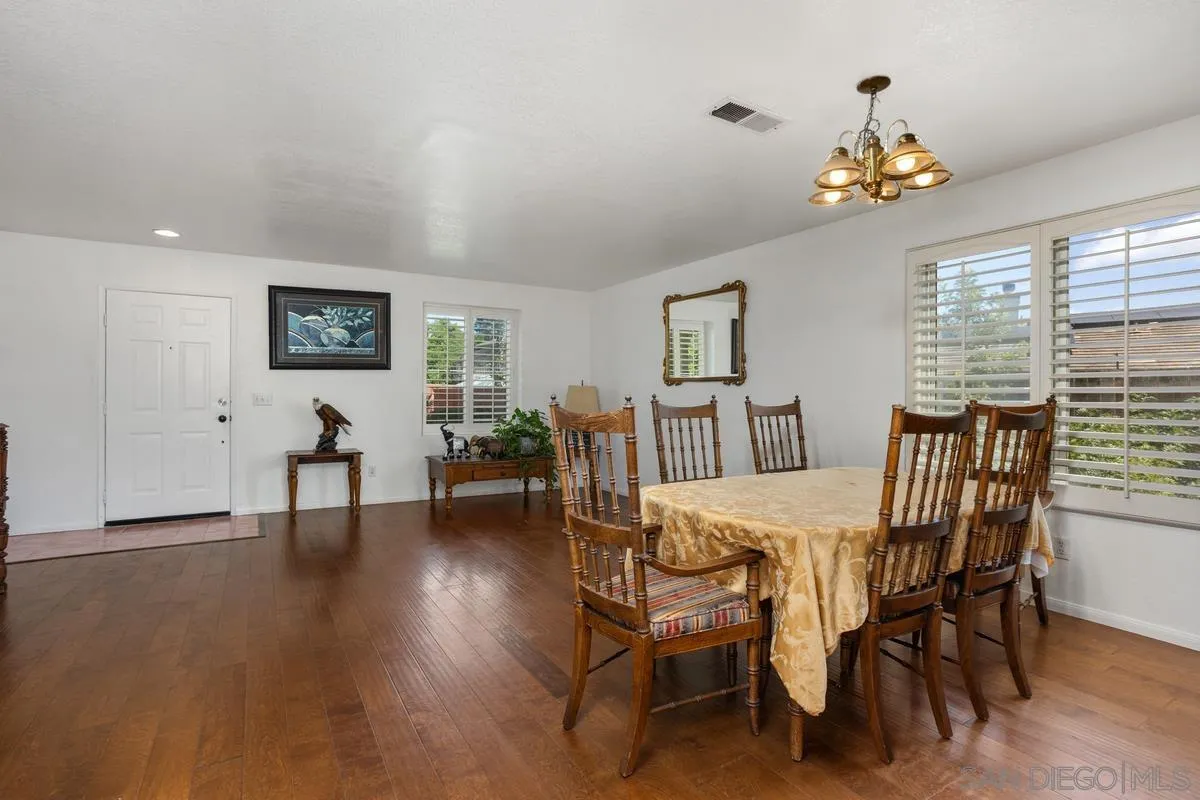 408 Shadow Tree Drive Oceanside, CA 92058 - Photo 7 of 29 a view of a dining room with furniture and a chandelier
