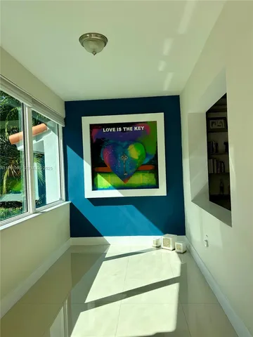 a living room with furniture flowers and a potted plant