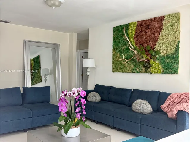 a living room with furniture and a book shelf