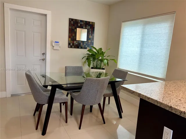 a kitchen with a sink stainless steel appliances a refrigerator and counter space