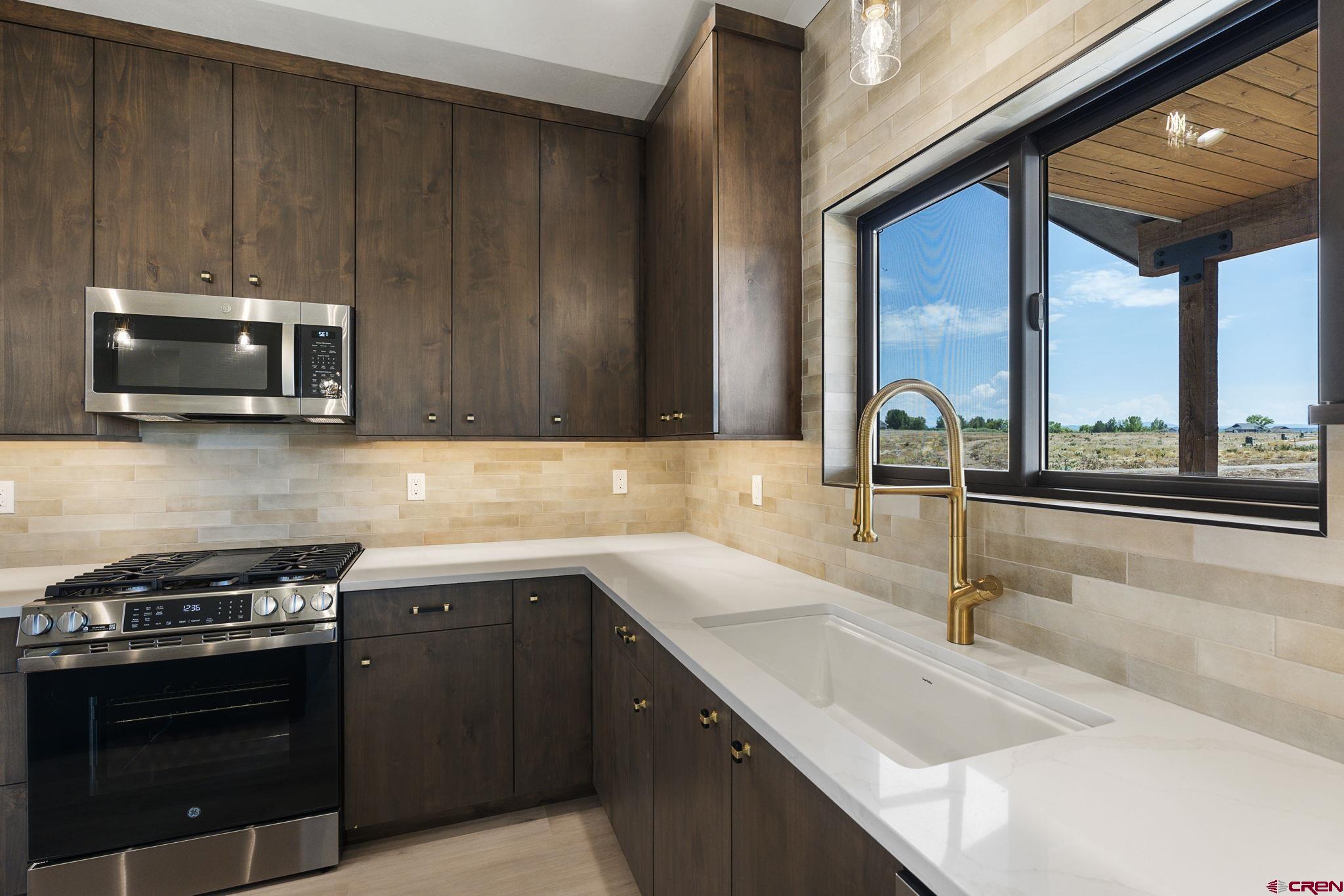 208 Petra Court Durango, CO 81303 - Photo 12 of 38 a kitchen with a sink stove and microwave