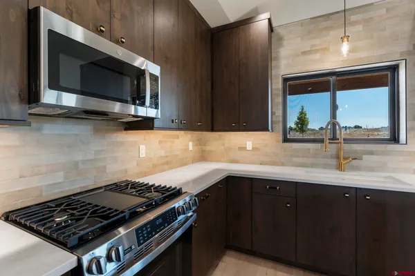 a kitchen with a sink and a microwave