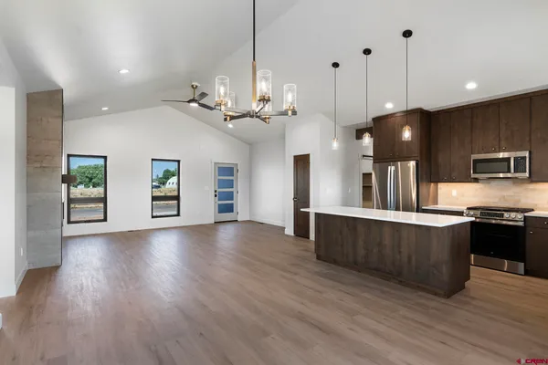 a view of a kitchen with sink and wooden floor