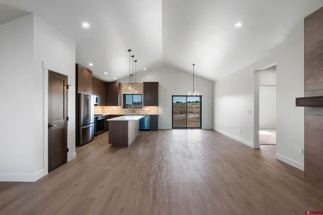 a kitchen with stainless steel appliances a refrigerator sink a stove and cabinets