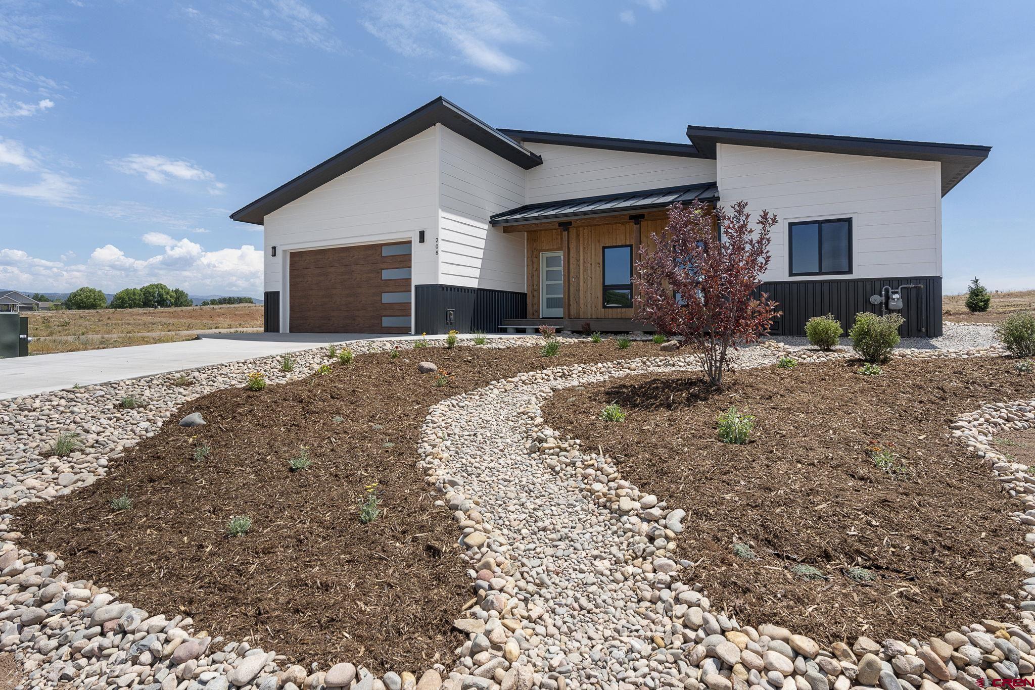 208 Petra Court Durango, CO 81303 - Photo 2 of 38 a front view of a house with a yard