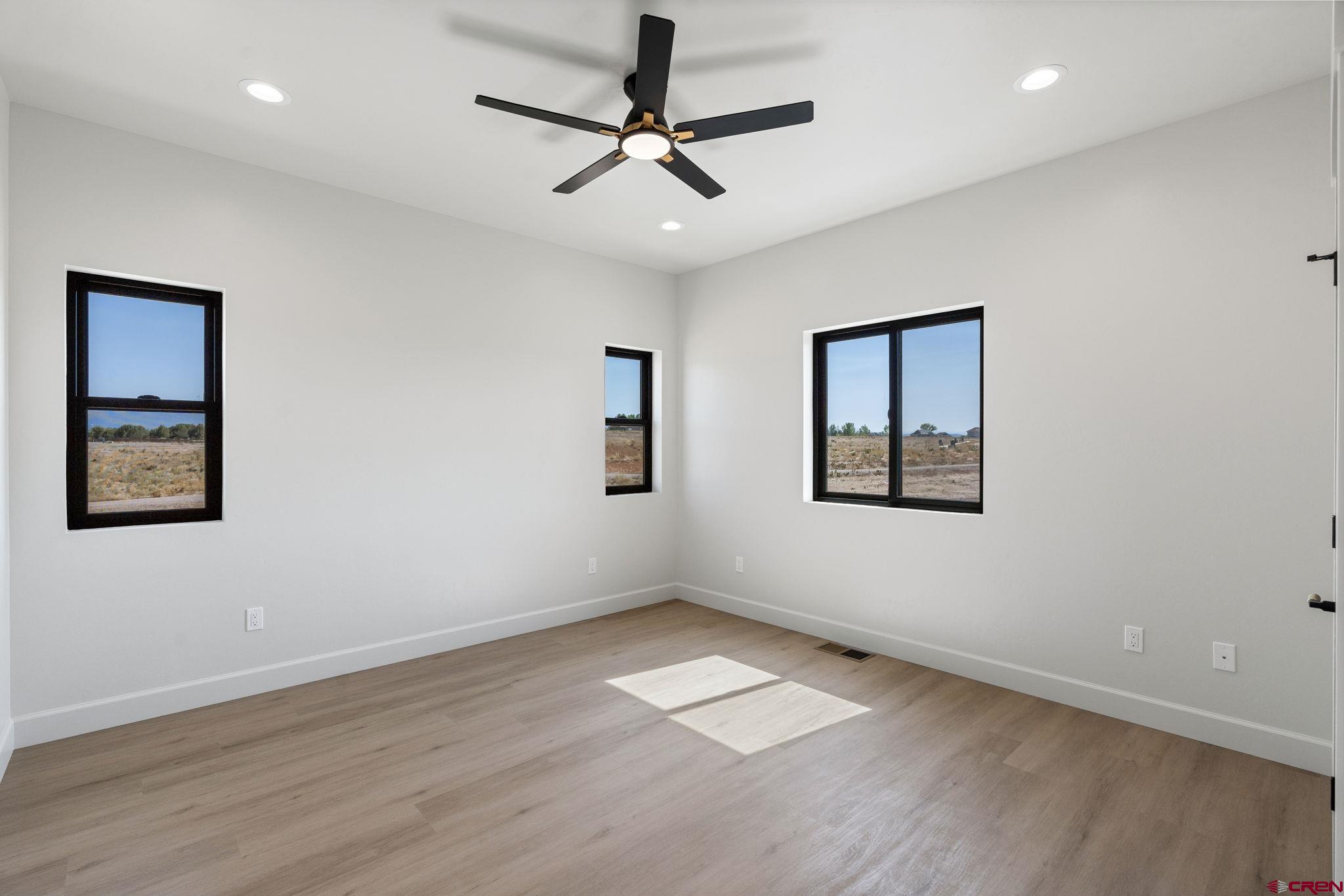 208 Petra Court Durango, CO 81303 - Photo 21 of 38 a view of empty room with wooden floor and fan