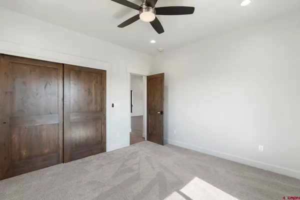 a view of empty room with ceiling fan