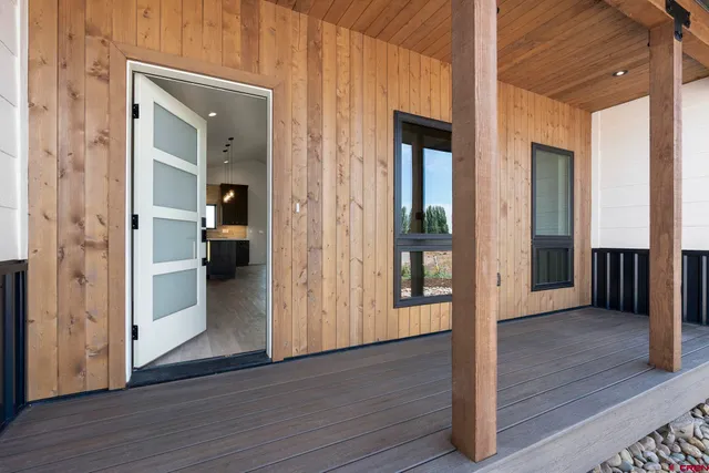 a view of a hallway with wooden floor and closet with fireplace