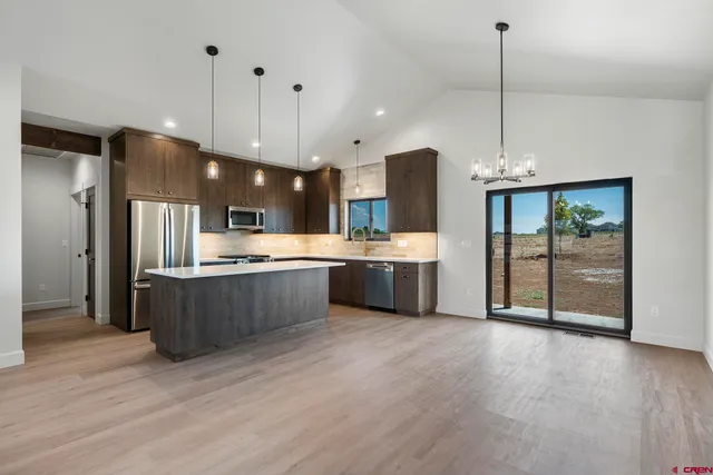a large kitchen with stainless steel appliances kitchen island a large island in the center