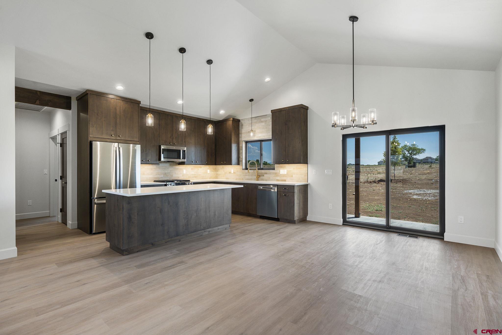 208 Petra Court Durango, CO 81303 - Photo 8 of 38 a large kitchen with stainless steel appliances kitchen island a large island in the center