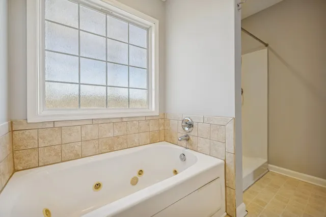 a bathroom with a tub and a shower