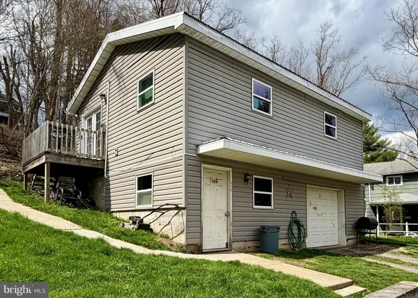 a view of house with yard