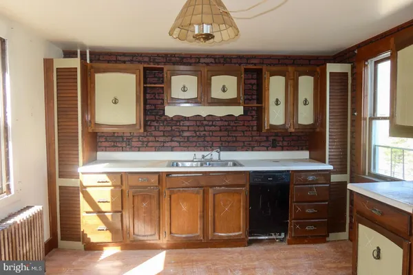 a bathroom with a sink a mirror and a shower