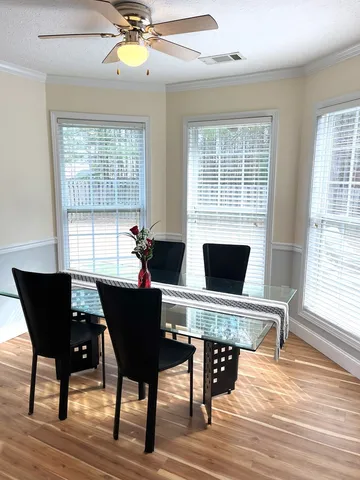 a view of a dining room with furniture window and wooden floor
