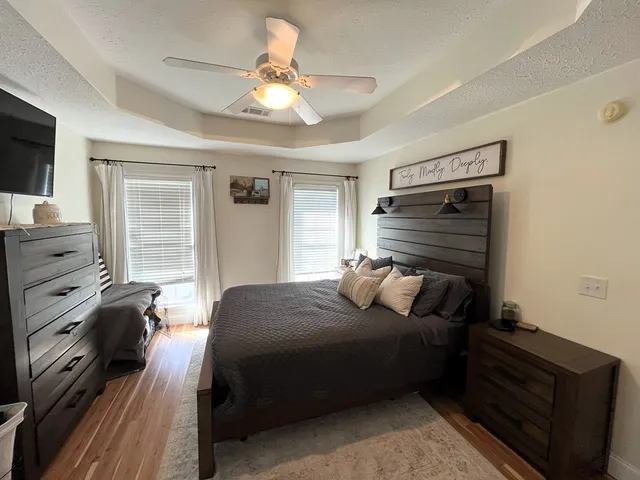 a bedroom with a bed and a flat tv screen