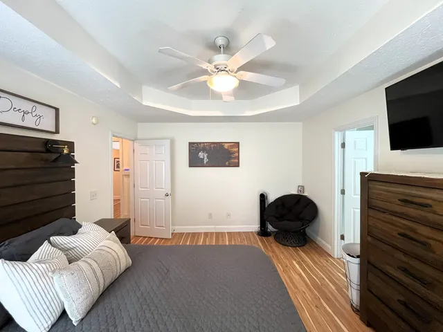 a bedroom with a bed and a flat screen tv