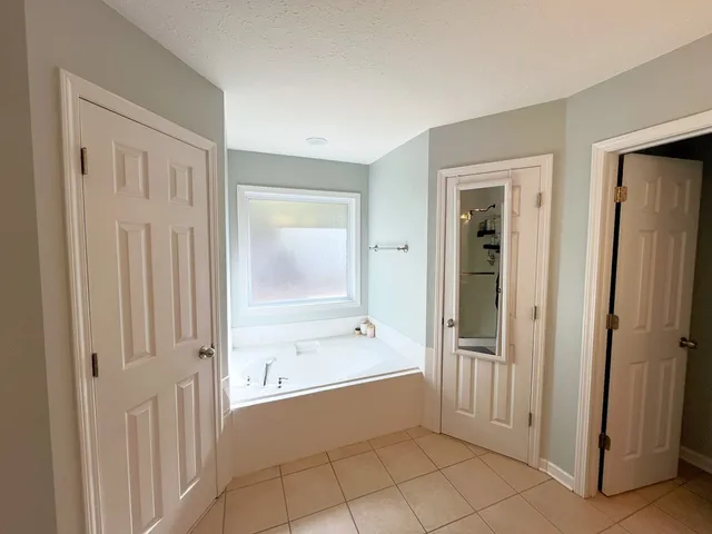 a bathroom with a bathtub and a shower
