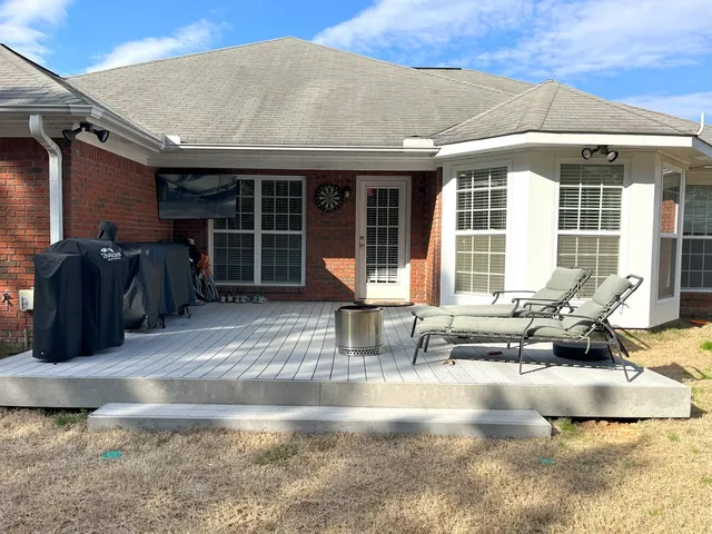 a view of a house with backyard and sitting area