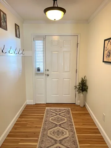 a view of a room with wooden floor and a chandelier