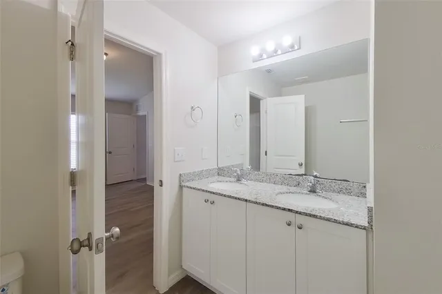 a bathroom with a granite countertop sink mirror and double