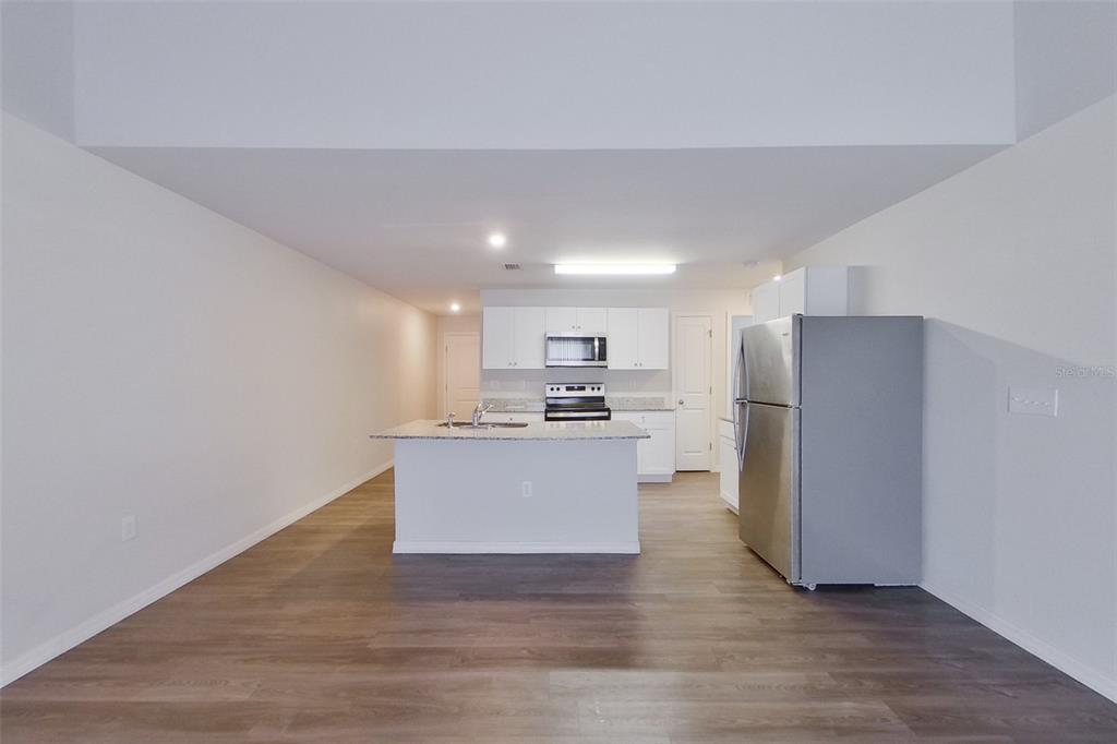 18318 Gibraltar Lane Lehigh Acres, FL 33936 - Photo 5 of 14 a view of kitchen with wooden floor