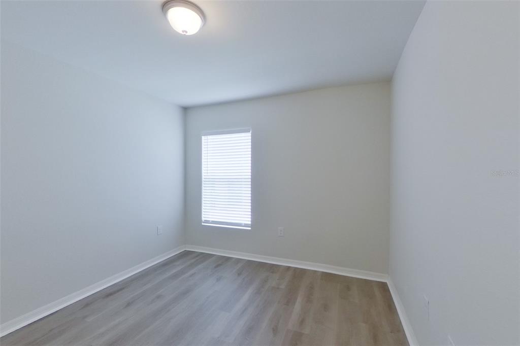 18318 Gibraltar Lane Lehigh Acres, FL 33936 - Photo 8 of 14 an empty room with a window