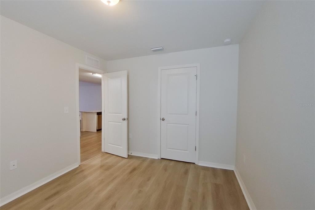 18318 Gibraltar Lane Lehigh Acres, FL 33936 - Photo 9 of 14 a view of an empty room and wooden floor