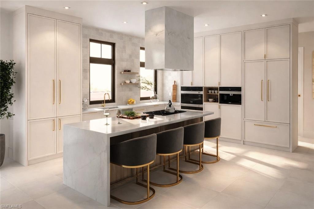 a kitchen with stainless steel appliances granite countertop a stove a chimney a sink and a refrigerator