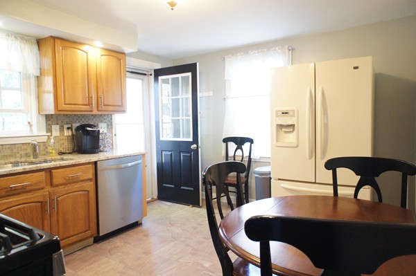 18 Vanness Road Weymouth, MA 02191 - Photo 4 of 19 a kitchen with a table chairs and refrigerator