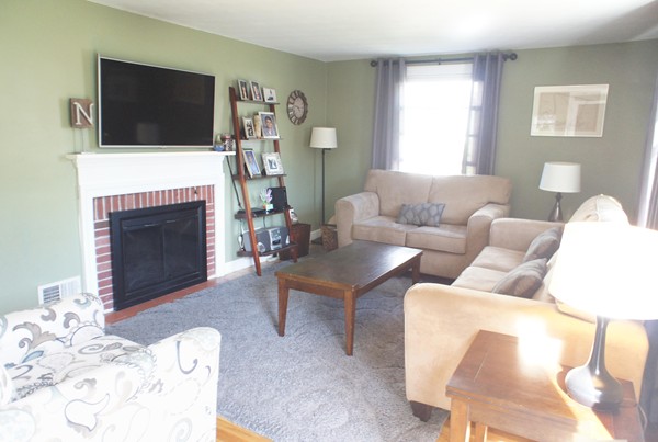 18 Vanness Road Weymouth, MA 02191 - Photo 5 of 19 a living room with furniture a fireplace and flat screen tv