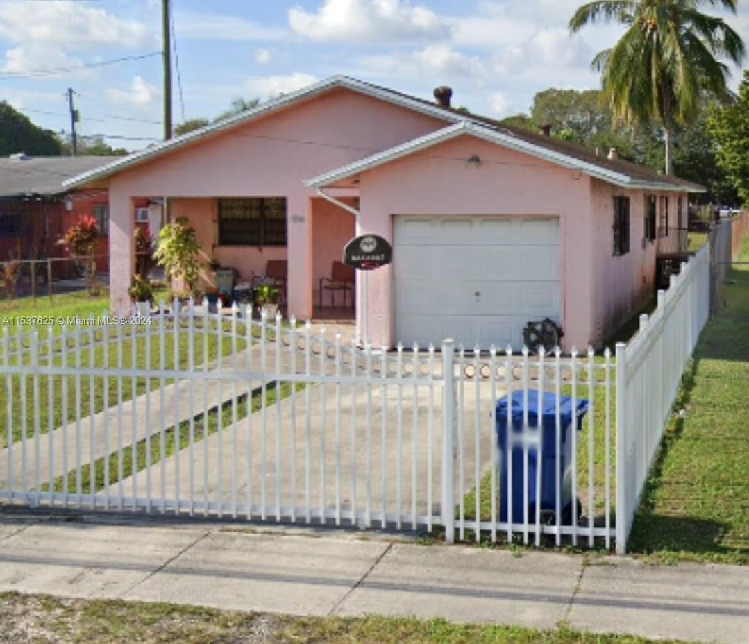 a front view of a house with a fence
