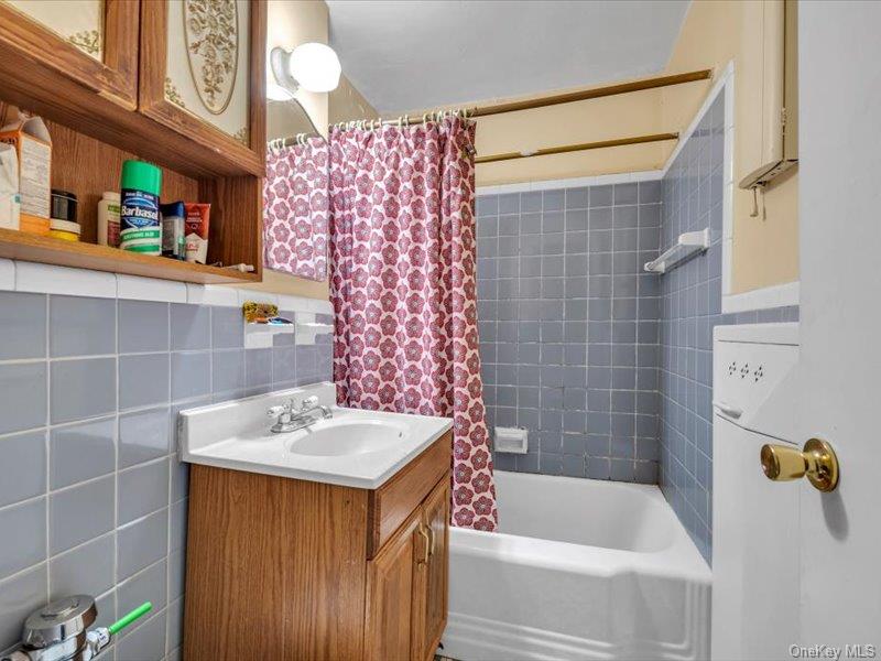 35-11 85th Street, Unit 1C Queens, NY 11372 - Photo 10 of 13 a bathroom with a sink and a bathtub