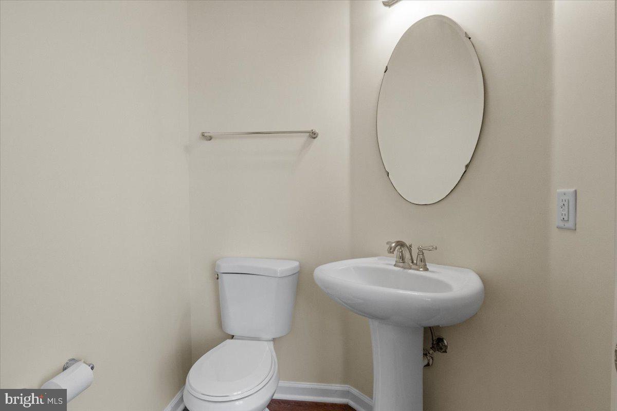 8329 Autumn Crest Lane, Unit 6 Chesapeake Beach, MD 20732 - Photo 18 of 30 a bathroom with a toilet sink and mirror