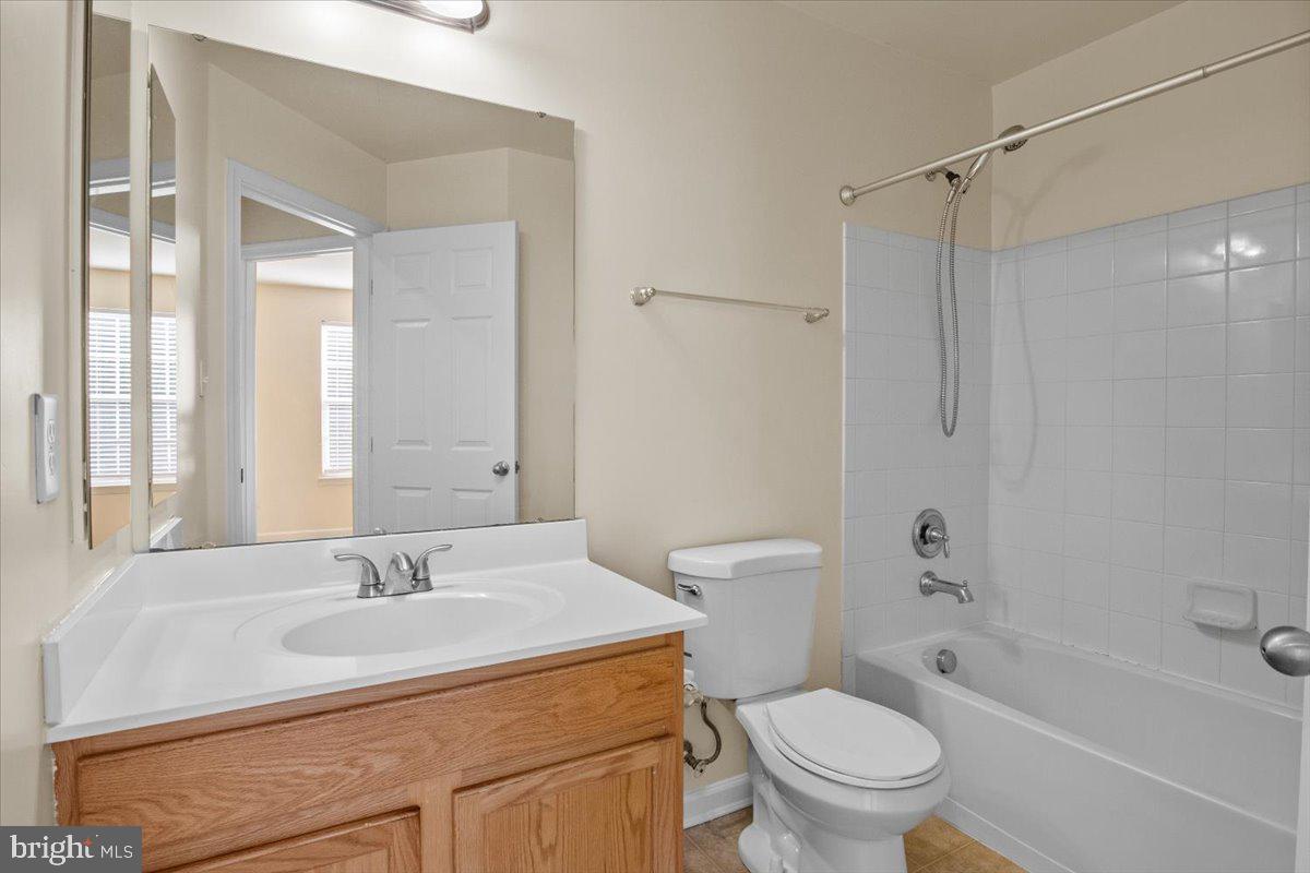 8329 Autumn Crest Lane, Unit 6 Chesapeake Beach, MD 20732 - Photo 24 of 30 a bathroom with a sink toilet vanity and shower