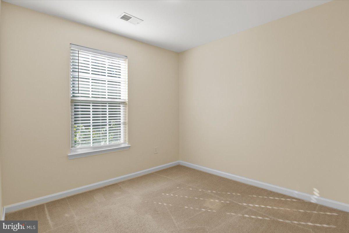 8329 Autumn Crest Lane, Unit 6 Chesapeake Beach, MD 20732 - Photo 25 of 30 a view of an empty room with a window