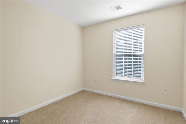 an empty room with closet area