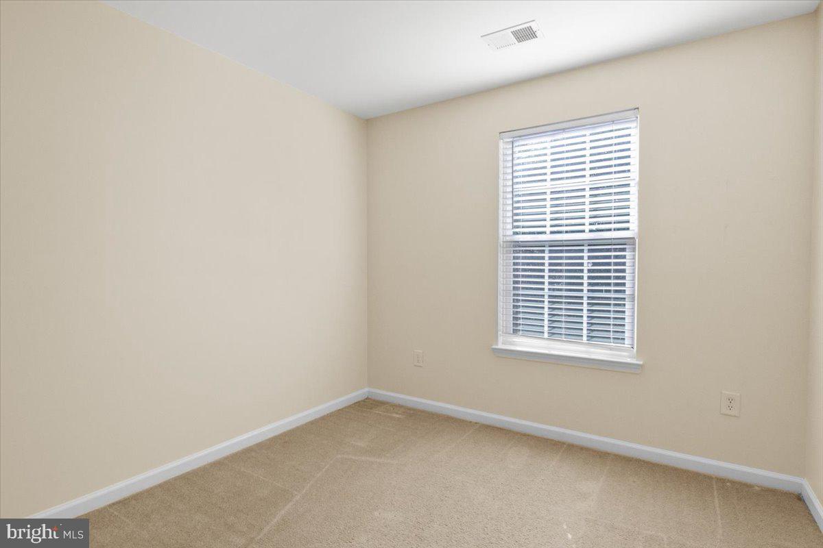 8329 Autumn Crest Lane, Unit 6 Chesapeake Beach, MD 20732 - Photo 27 of 30 a view of an empty room with a window