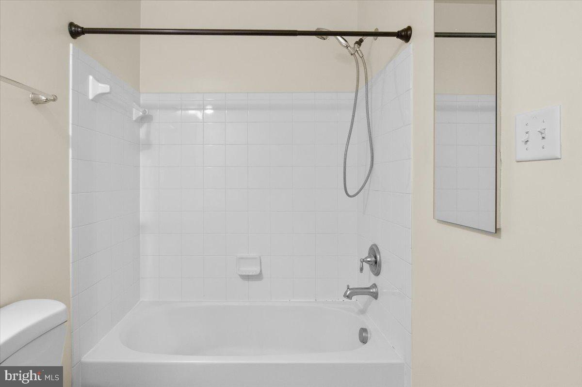 8329 Autumn Crest Lane, Unit 6 Chesapeake Beach, MD 20732 - Photo 29 of 30 a bathroom with a bath tub with a shower