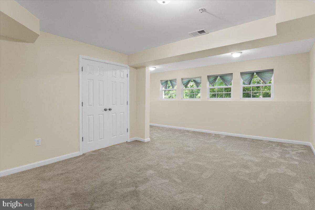 8329 Autumn Crest Lane, Unit 6 Chesapeake Beach, MD 20732 - Photo 6 of 30 an empty room with windows and closet