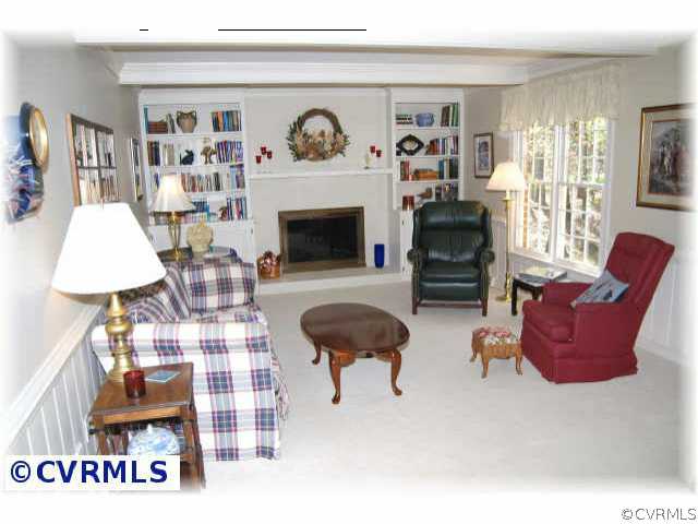 3001 East Brigstock Road Midlothian, VA 23113 - Photo 3 of 10 a living room with furniture and a fireplace