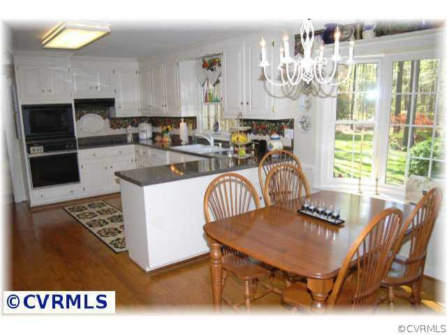 3001 East Brigstock Road Midlothian, VA 23113 - Photo 5 of 10 a dinning table sitting in a kitchen next to a window with kitchen view