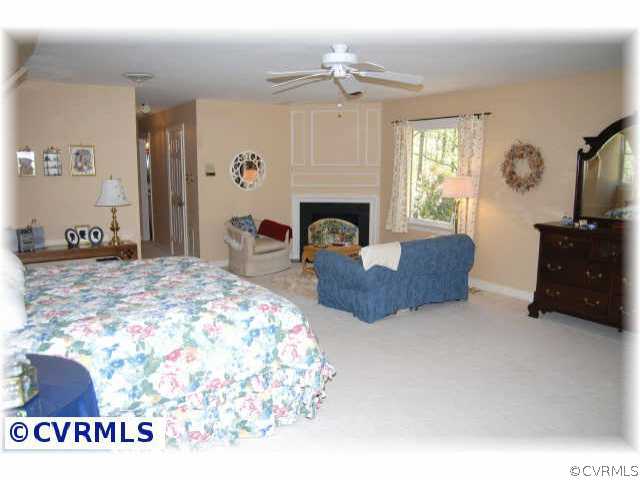 3001 East Brigstock Road Midlothian, VA 23113 - Photo 7 of 10 a bedroom with a bed and a fireplace
