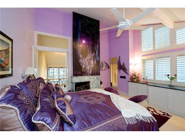 39 Port Of Spain Road Coronado, CA 92118 - Photo 14 of 25 Tall ceilings, balcony overlooking the living room, gas fireplace, plantation shutters and a TV hidden! Be the star of your own home in this bedroom.