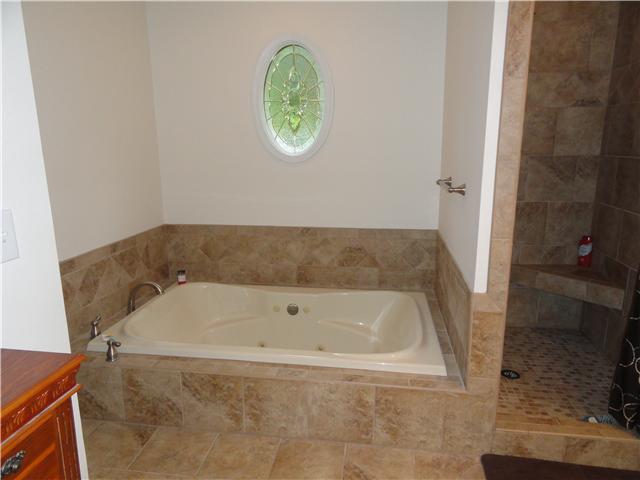 726 Vaughan Road Clarksville, TN 37043 - Photo 14 of 20 Separate shower and whirlpool tub. Newly tiled shower, tile surrounding tub, and tiled floor are gorgeous. Double vanity, private toilet area.