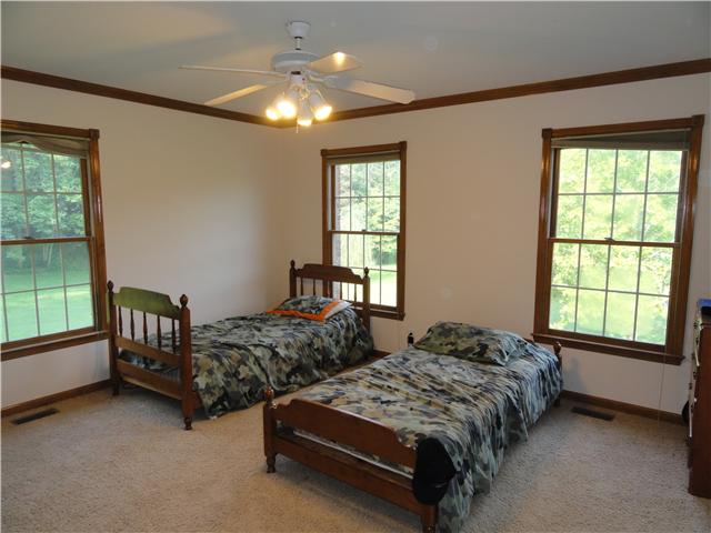 726 Vaughan Road Clarksville, TN 37043 - Photo 16 of 20 One of three large, main level bedrooms with entry to covered deck. New carpet and paint in addition to three beautiful windows for lots of natural light.
