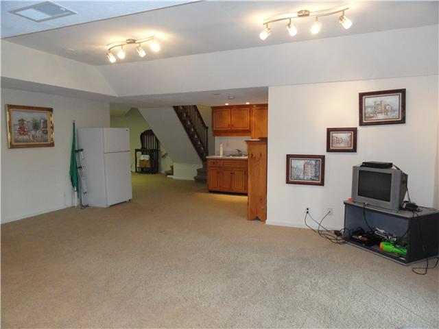 726 Vaughan Road Clarksville, TN 37043 - Photo 19 of 20 Another view of basement finished space showcasing the built-in cabinets and flex space off of the stairs, perfect for an office, game area, hobby room, or exercise space.
