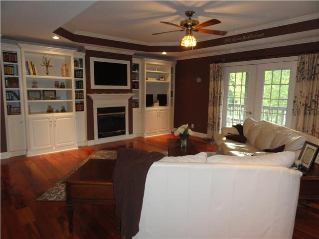 726 Vaughan Road Clarksville, TN 37043 - Photo 4 of 20 Large open Great Room makes a great first impression. Brazilian hardwood floors extend to dining room, master bedroom. Great built-in shelving and television convey. French doors lead to the covered deck and provide great natural light.