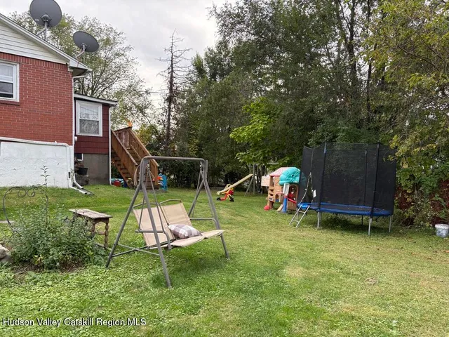 a view of a room with furniture and a table